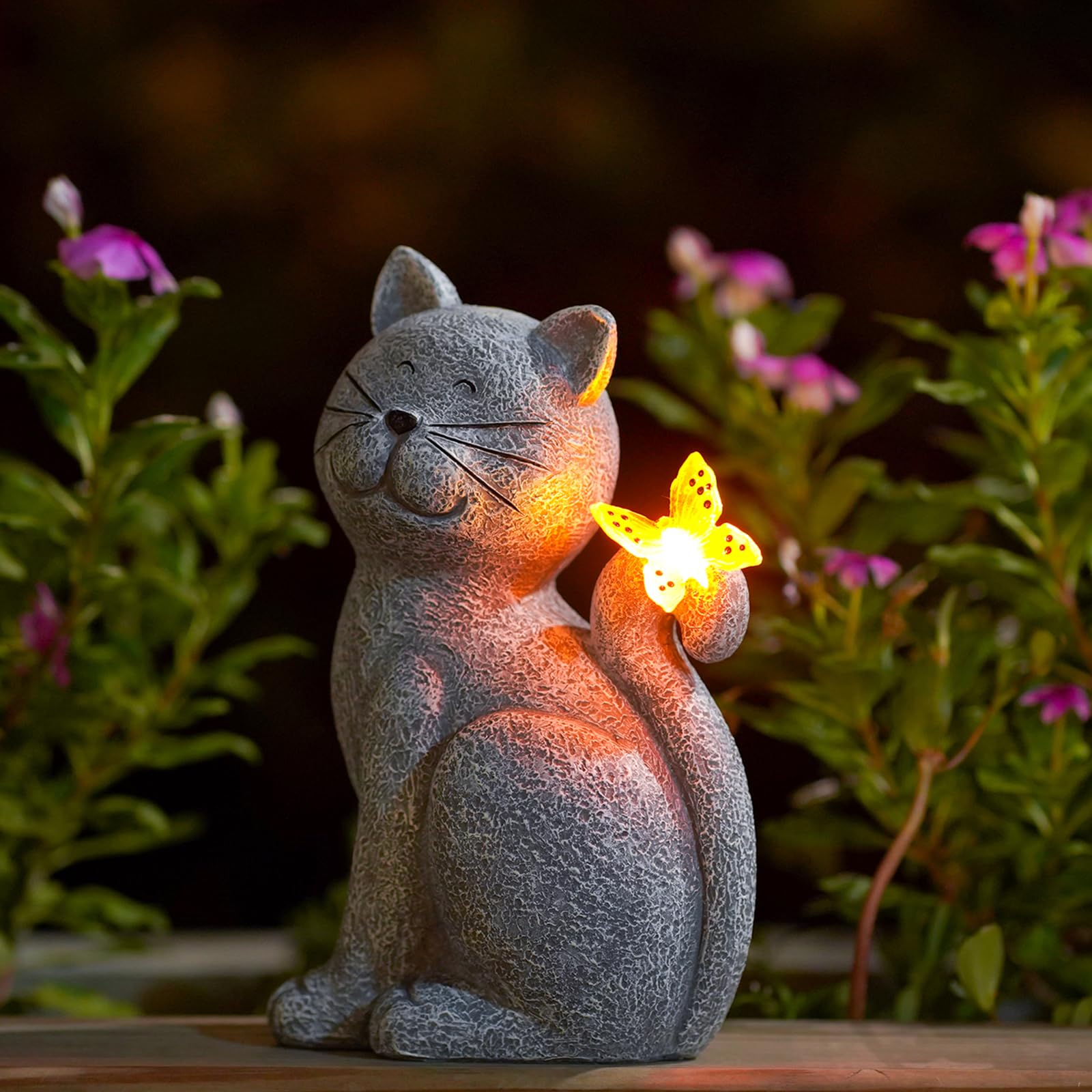 Solar cat statue with glowing butterfly